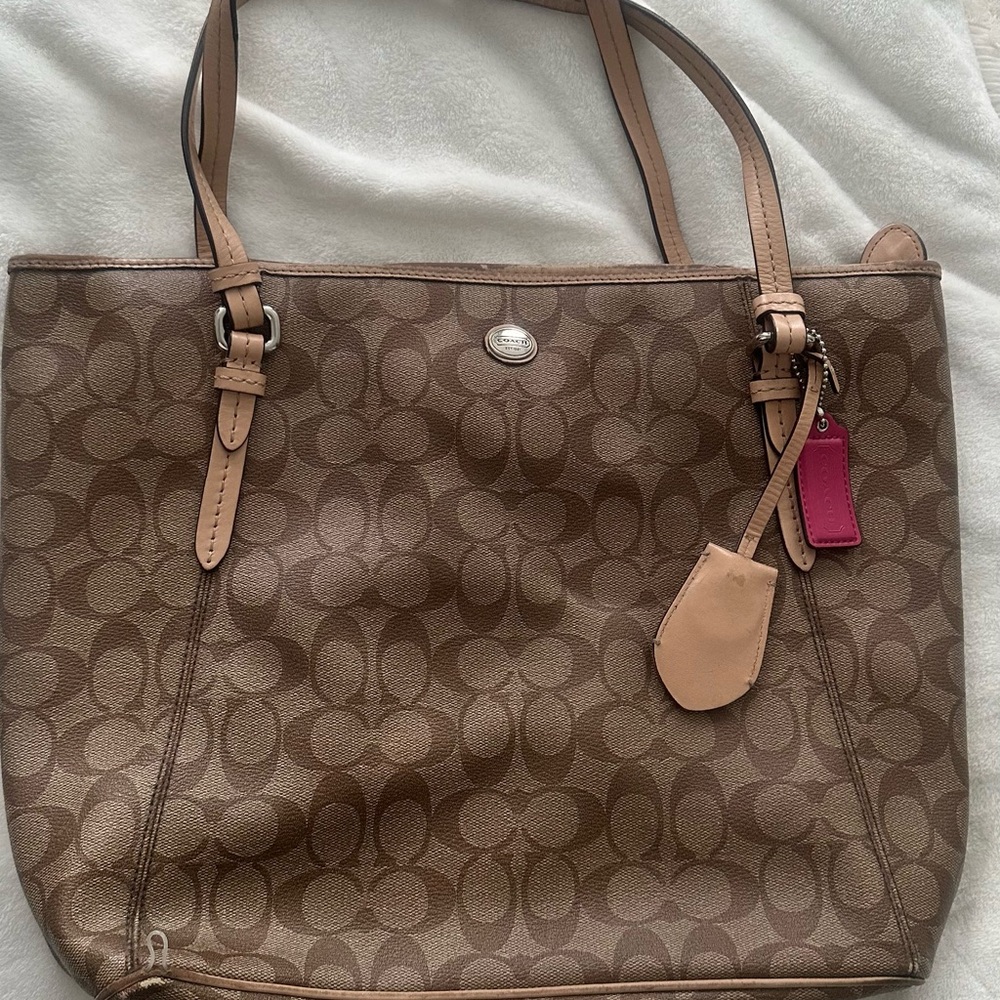 Coach Tan Signature Tote with Pink Tag
11inches deep, 14 inches wide